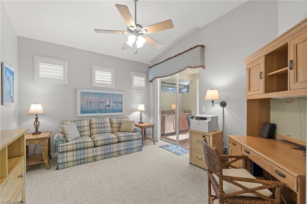 10205 Cape Roman Road Bonita Springs, FL 34135 - Photo 15 of 31 a living room with furniture a fireplace and a chandelier