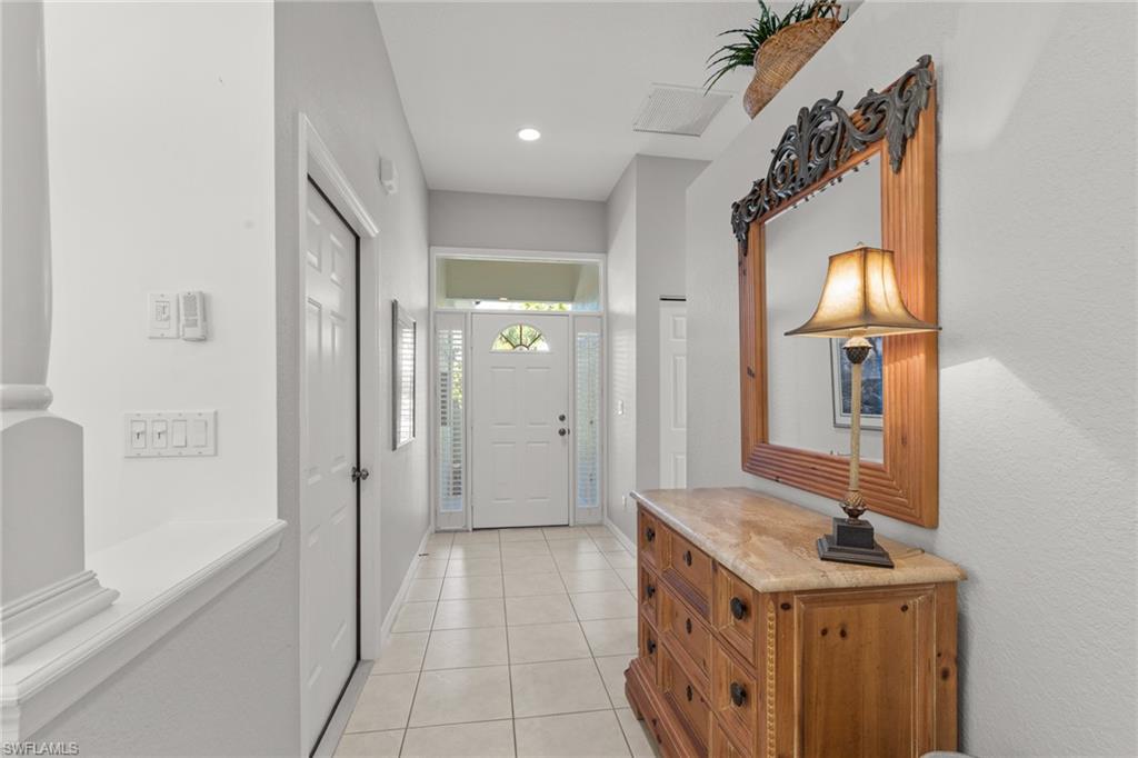 10205 Cape Roman Road Bonita Springs, FL 34135 - Photo 19 of 31 a bathroom with a sink and a mirror