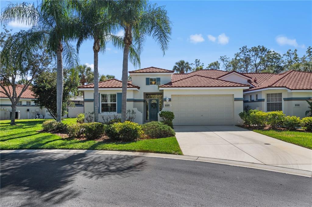 10205 Cape Roman Road Bonita Springs, FL 34135 - Photo 22 of 31 a front view of a house with a garden