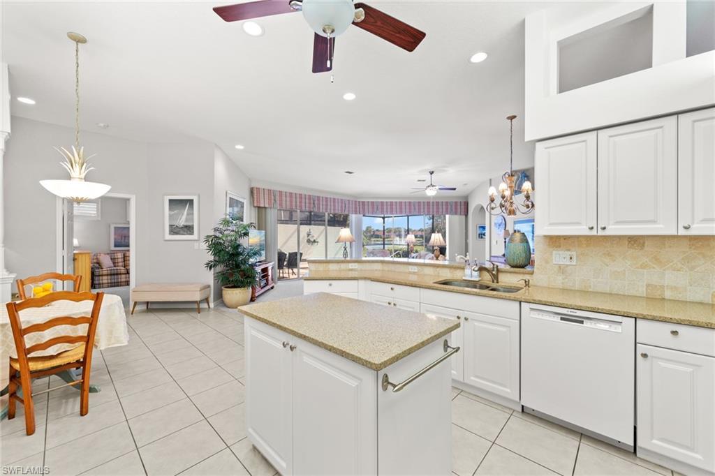 10205 Cape Roman Road Bonita Springs, FL 34135 - Photo 5 of 31 a kitchen with a sink and chairs