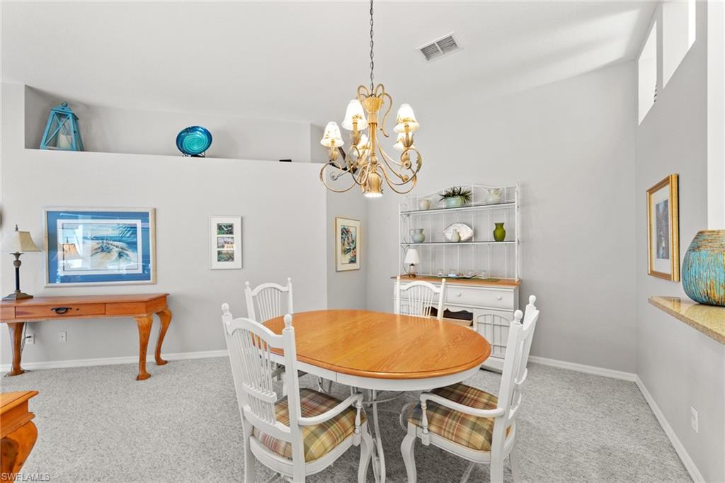 10205 Cape Roman Road Bonita Springs, FL 34135 - Photo 7 of 31 a view of a dining room with furniture and a chandelier