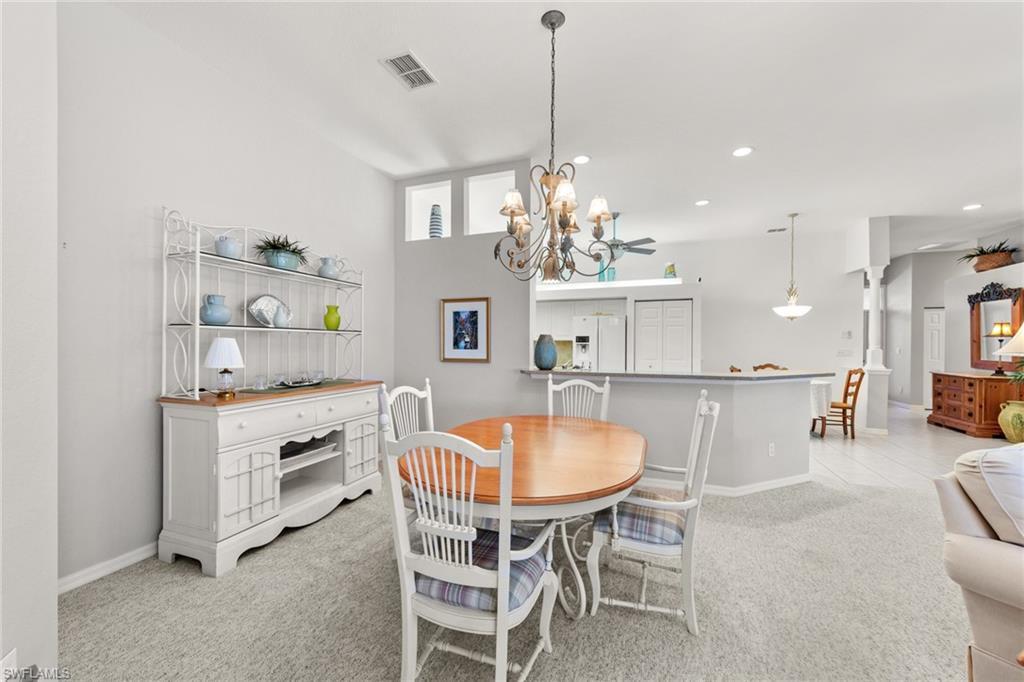 10205 Cape Roman Road Bonita Springs, FL 34135 - Photo 8 of 31 a room with stainless steel appliances a table and chairs