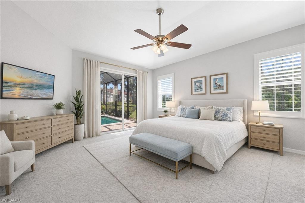 10205 Cape Roman Road Bonita Springs, FL 34135 - Photo 10 of 31 a spacious bedroom with a bed and a flat screen tv