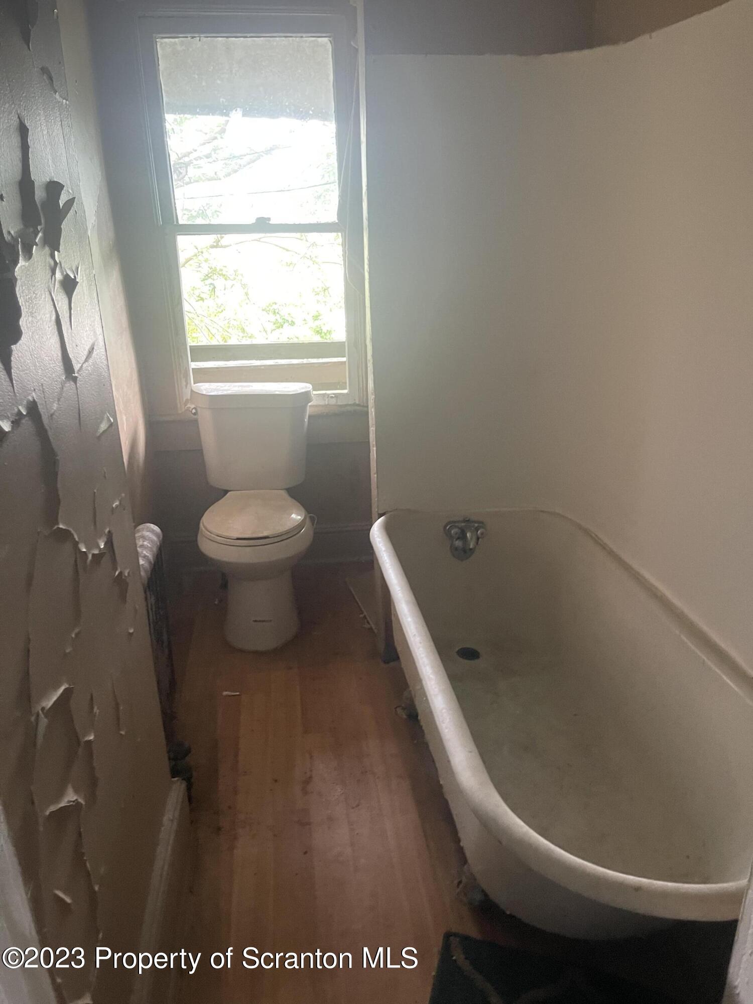 831 Monroe Avenue Scranton, PA 18510 - Photo 14 of 35 a bathroom with a toilet and a window