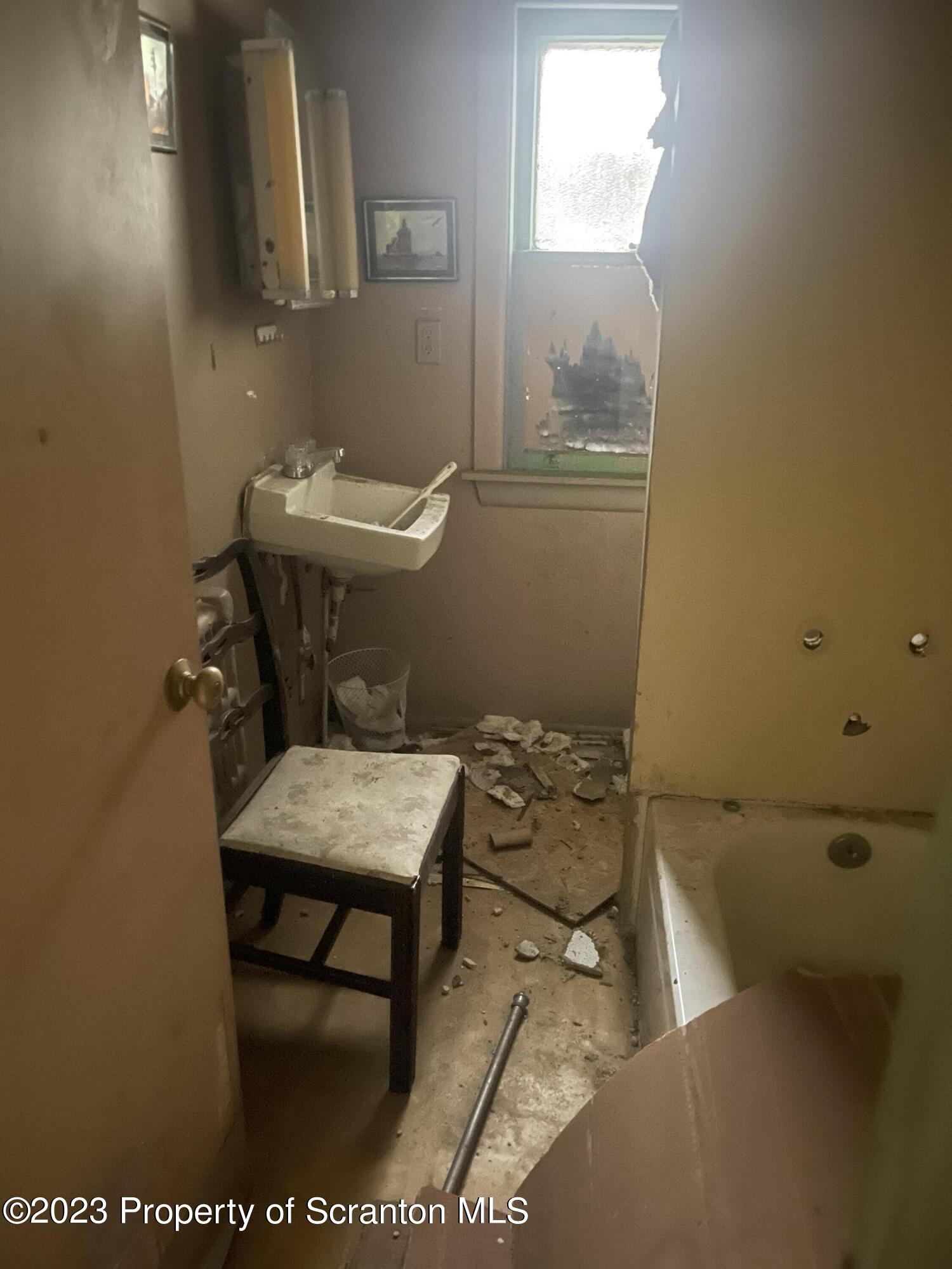 831 Monroe Avenue Scranton, PA 18510 - Photo 16 of 35 a bathroom with a sink a toilet and a mirror