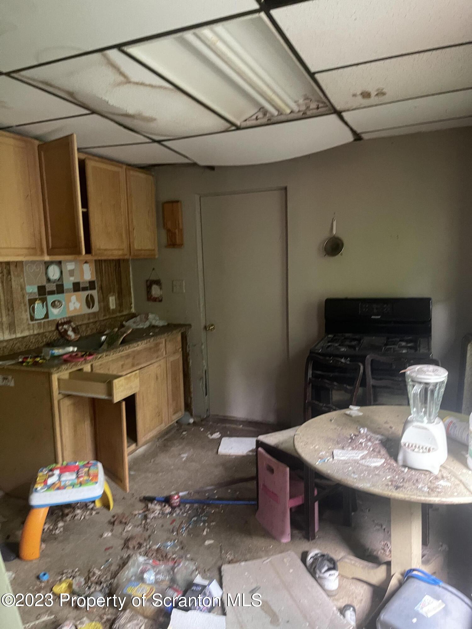 831 Monroe Avenue Scranton, PA 18510 - Photo 21 of 35 a kitchen with a sink and a stove