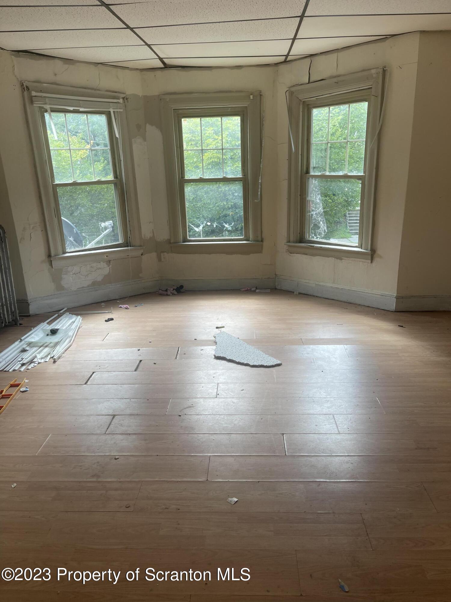 831 Monroe Avenue Scranton, PA 18510 - Photo 22 of 35 a view of an empty room with wooden floor and fan