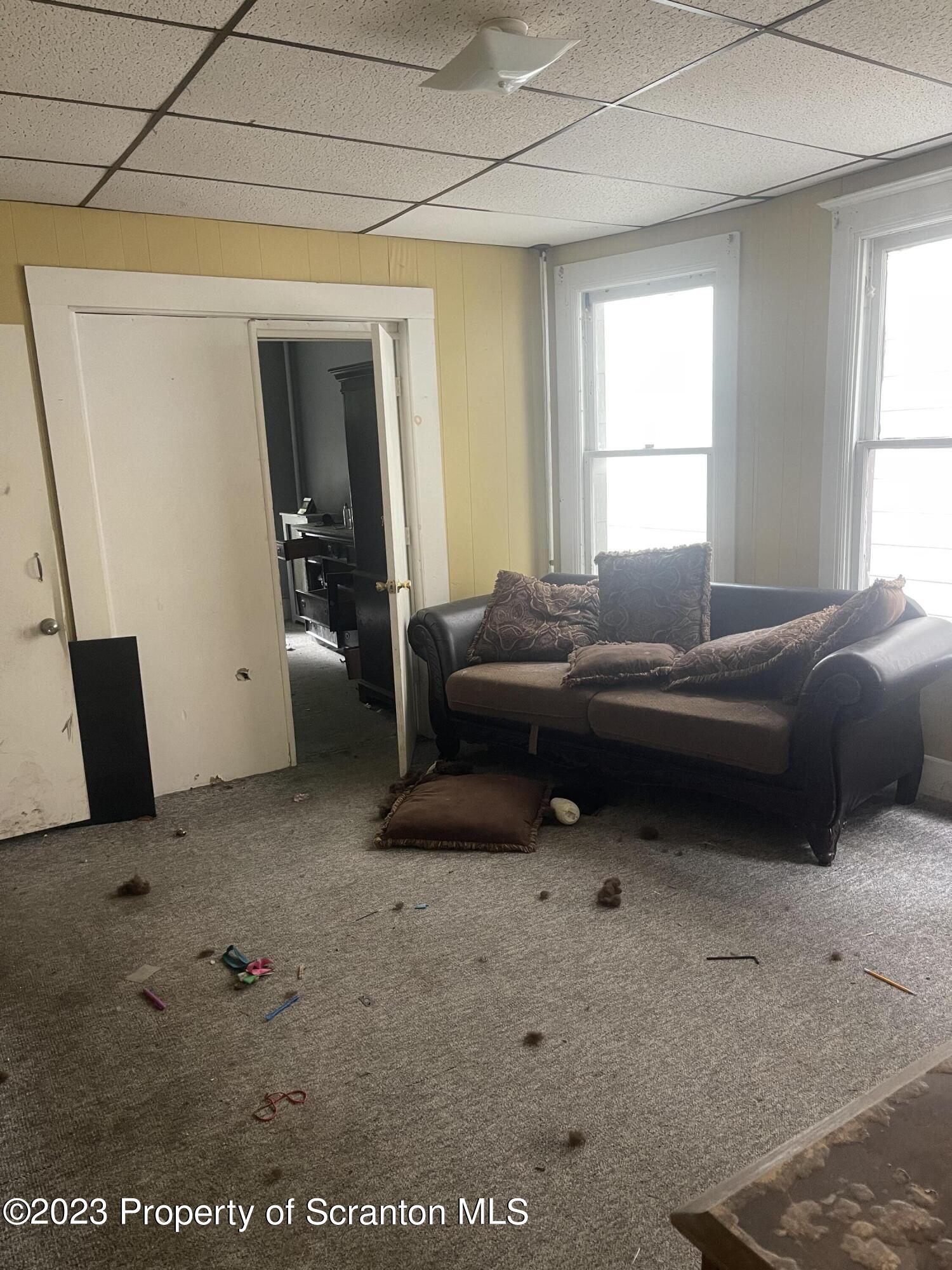 831 Monroe Avenue Scranton, PA 18510 - Photo 27 of 35 a living room with furniture a window and a flat screen tv