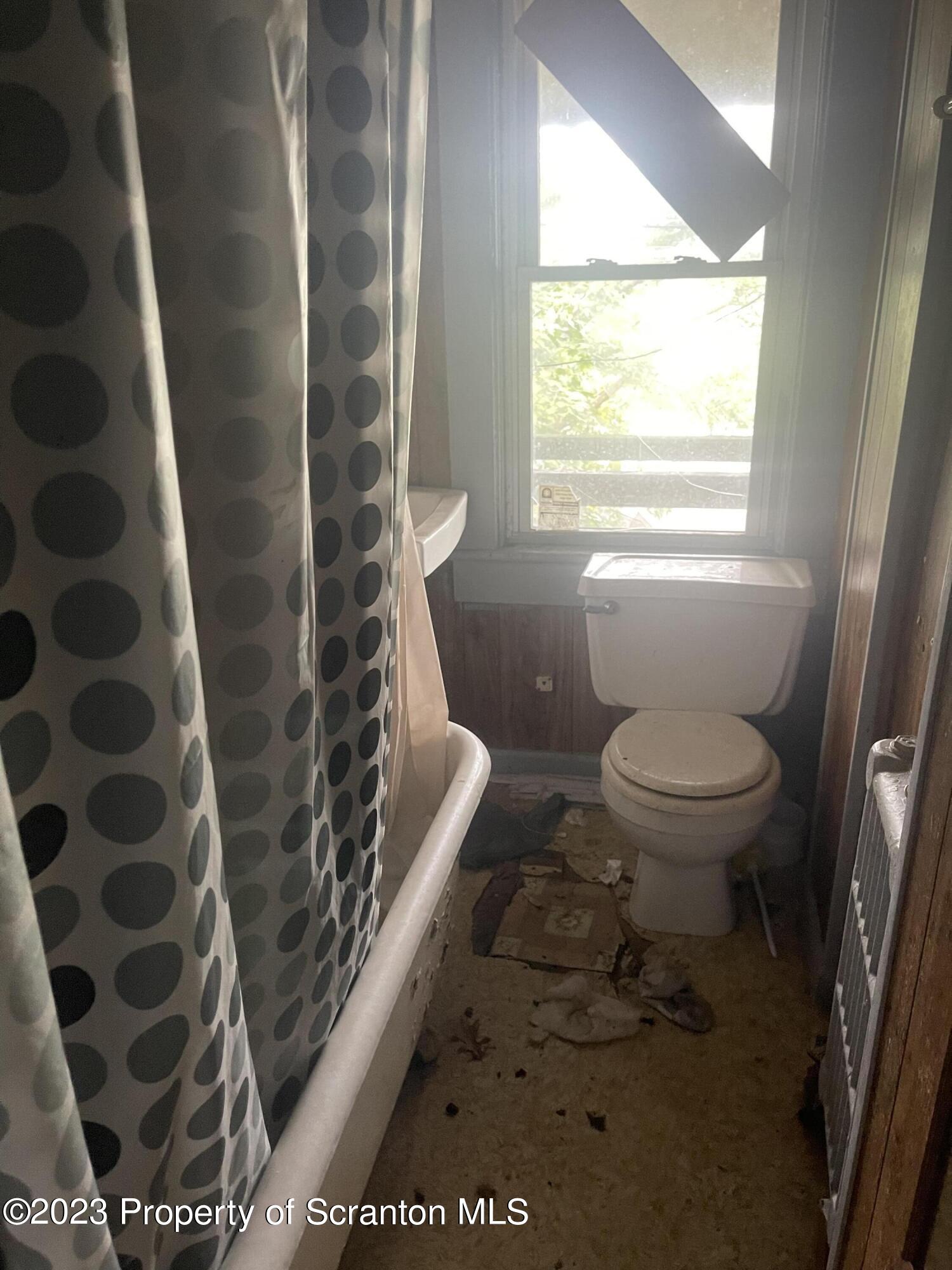831 Monroe Avenue Scranton, PA 18510 - Photo 3 of 35 a bathroom with a toilet and a shower