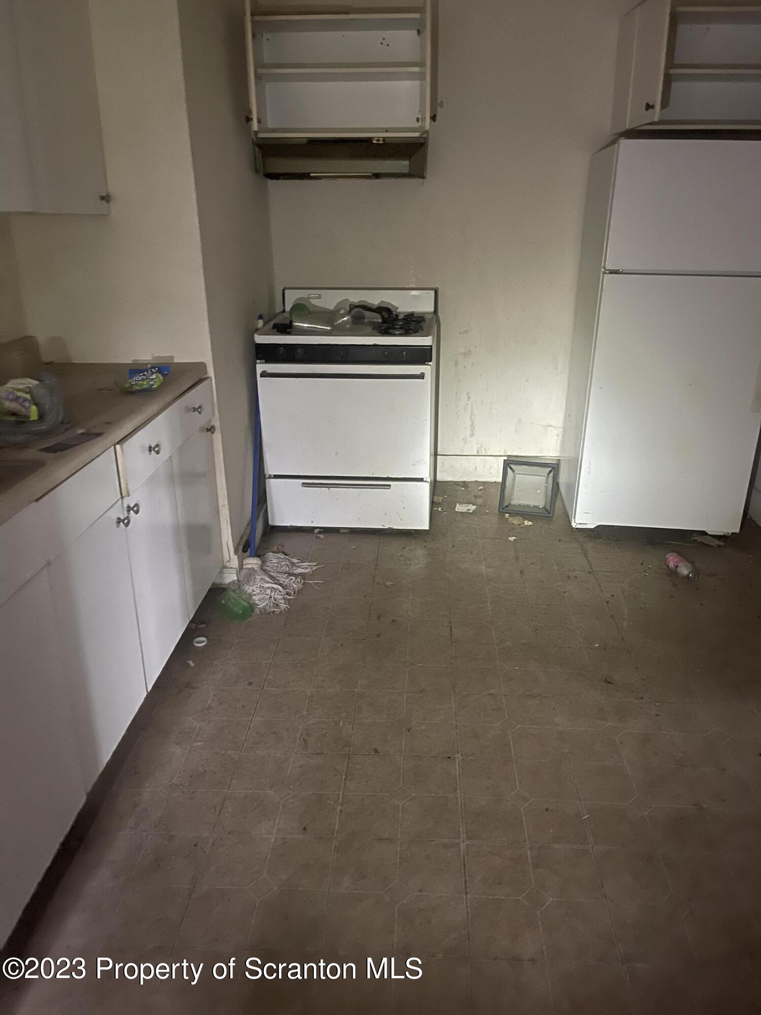 831 Monroe Avenue Scranton, PA 18510 - Photo 31 of 35 a kitchen with a stove and a microwave