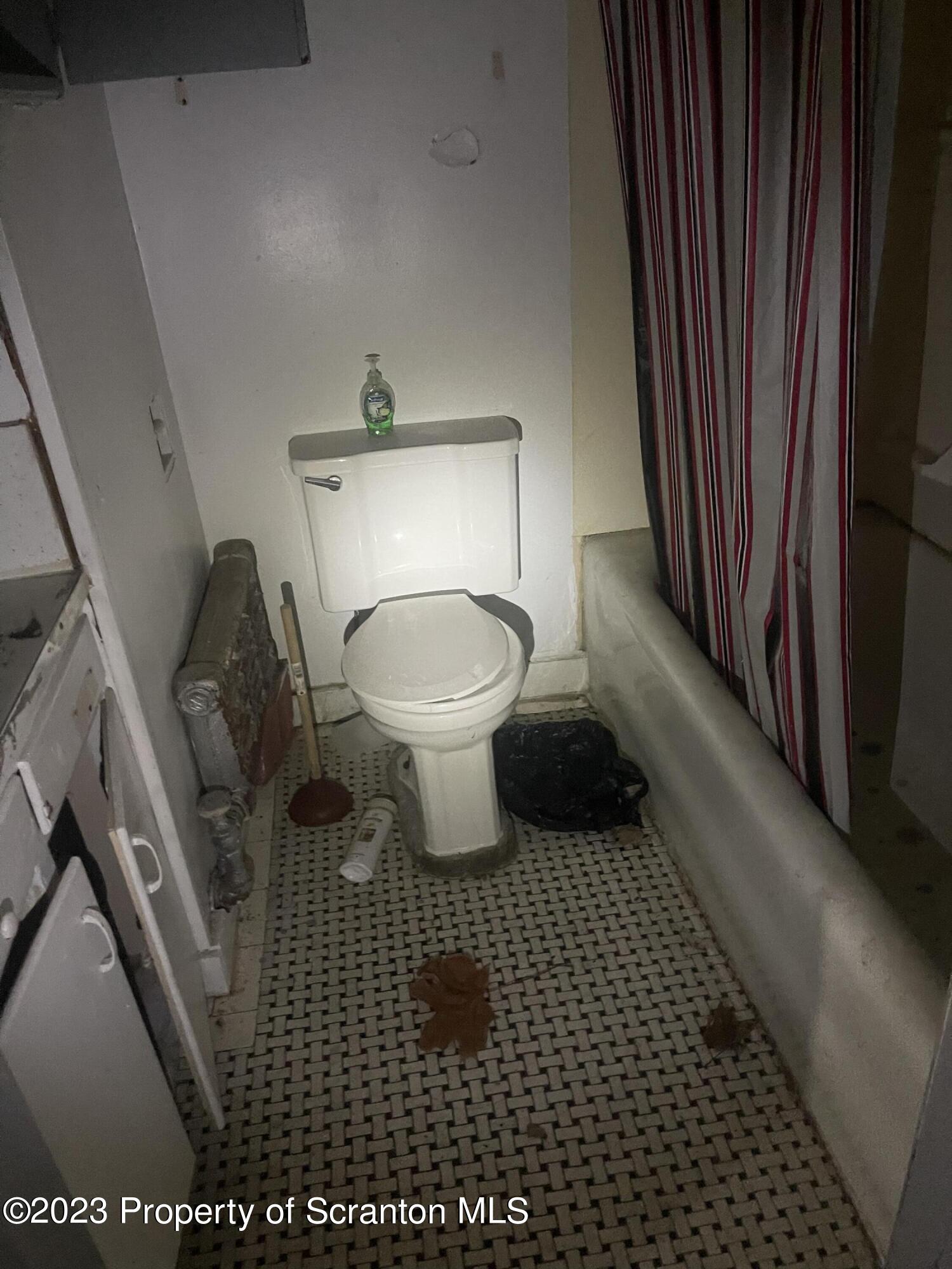 831 Monroe Avenue Scranton, PA 18510 - Photo 32 of 35 a bathroom with a toilet a sink and mirror