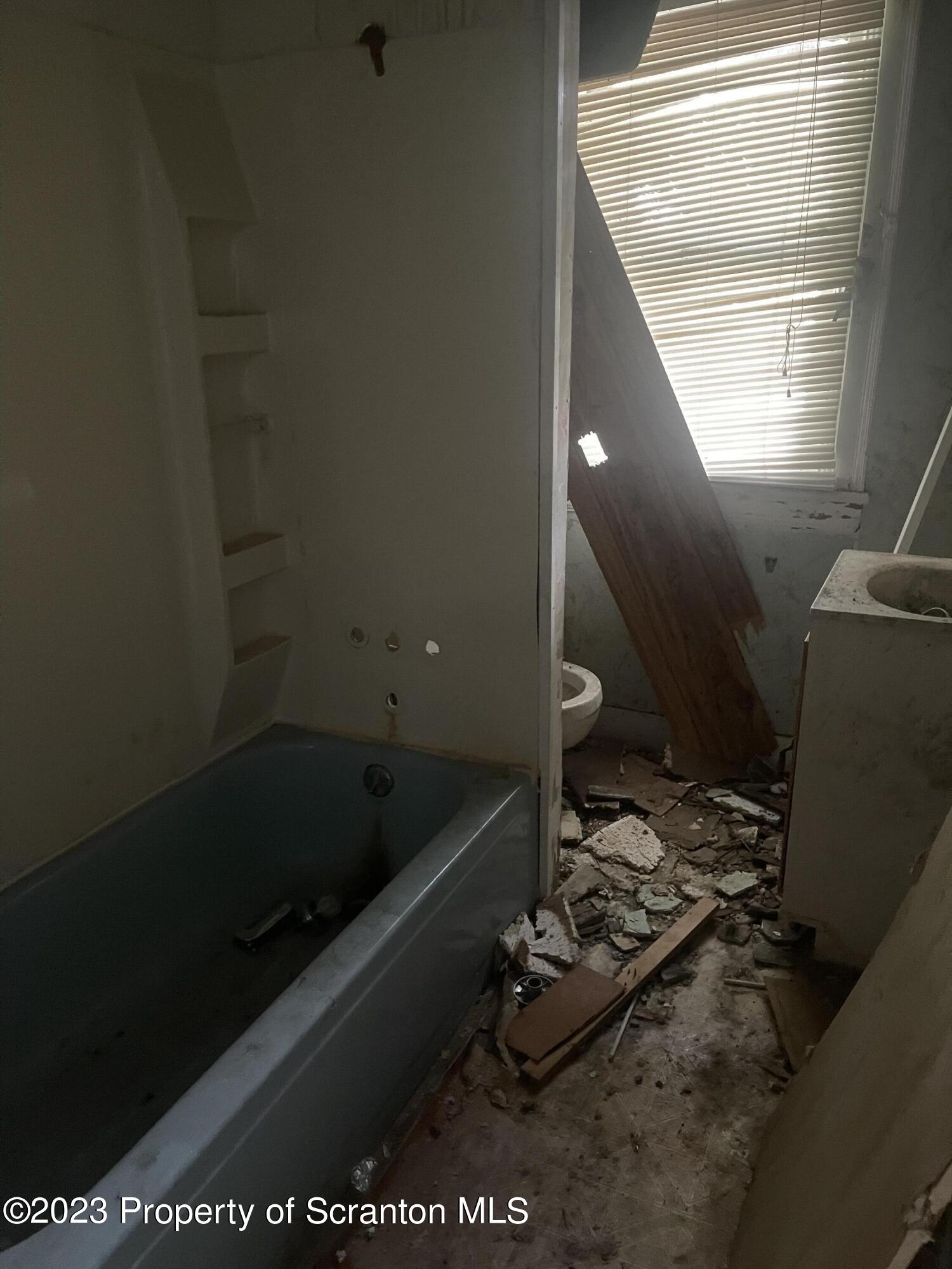 831 Monroe Avenue Scranton, PA 18510 - Photo 7 of 35 a bathroom with a bathtub and a window