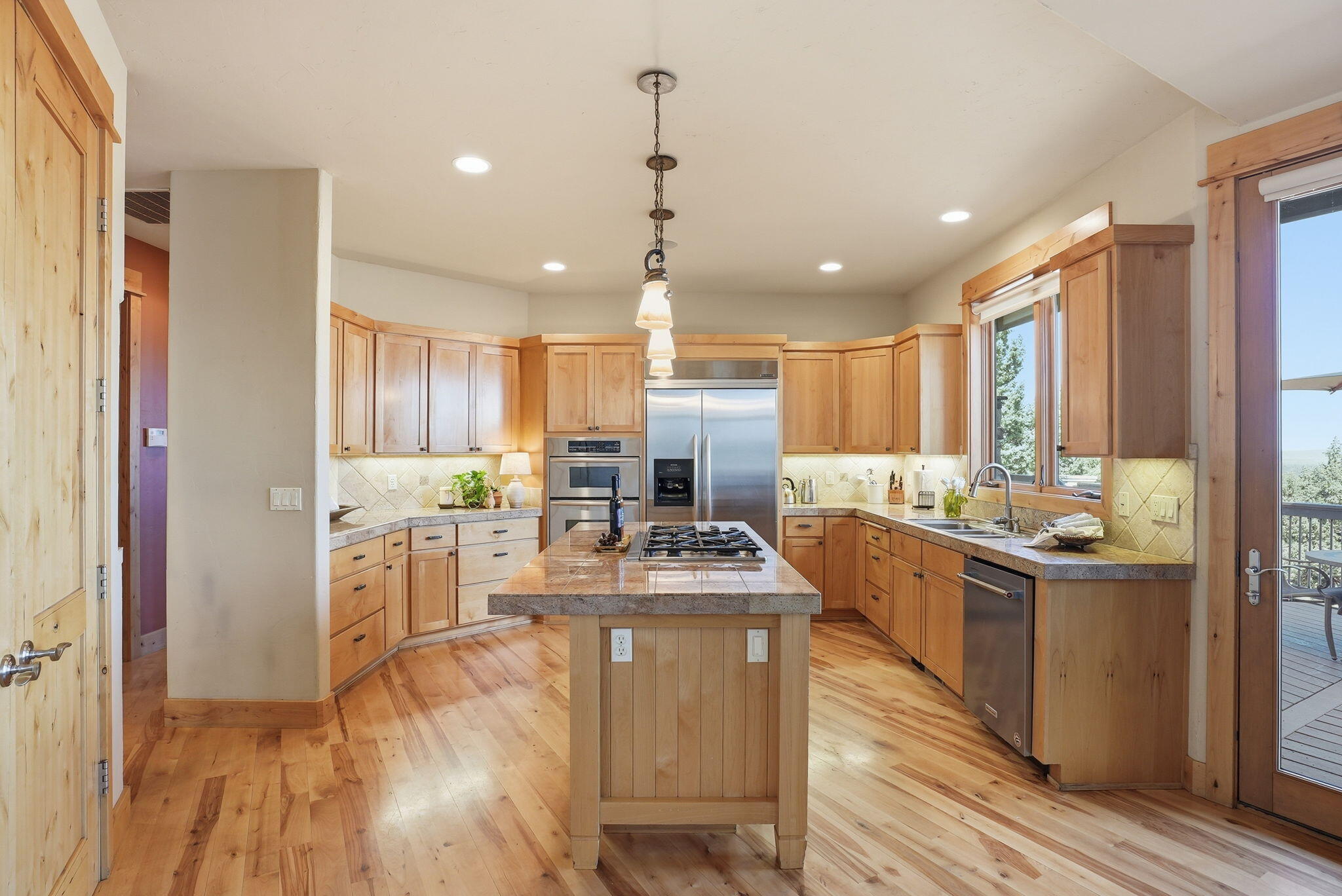 631 Sundance Ridge Court Redmond, OR 97756 - Photo 27 of 61 a kitchen with kitchen island granite countertop lots of counter top space and stainless steel appliances