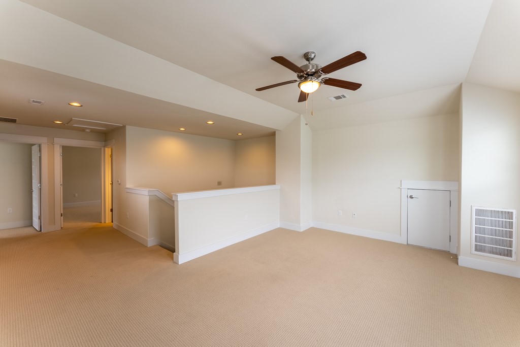 13008 Armaga Springs Road Austin, TX 78727 - Photo 22 of 33 Spare room featuring light carpet, recessed lighting, and a ceiling fan