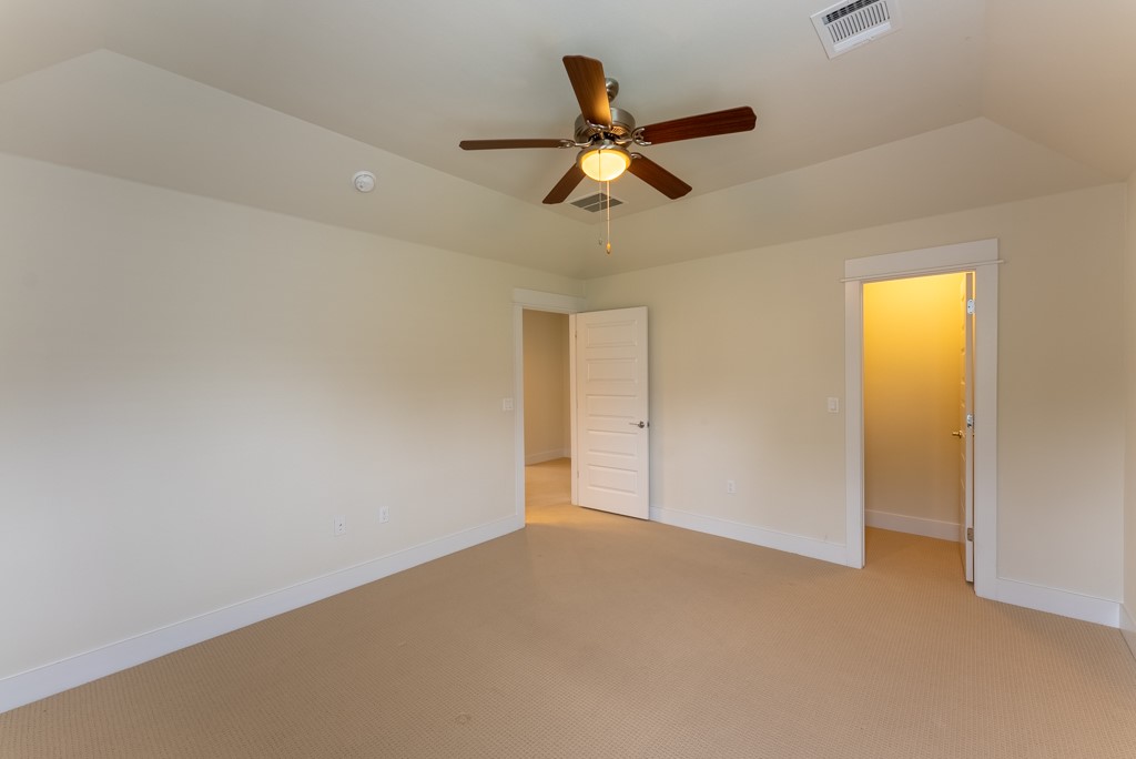 13008 Armaga Springs Road Austin, TX 78727 - Photo 28 of 33 Unfurnished bedroom with light carpet and ceiling fan