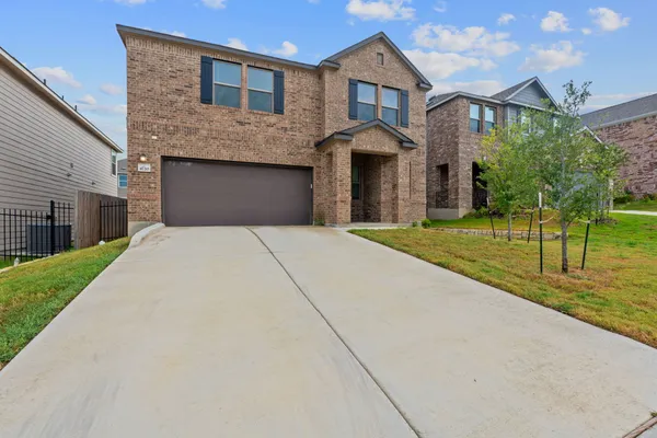 a front view of a house with a yard and garage
