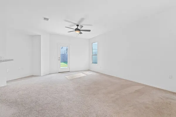 a view of empty room with ceiling fan