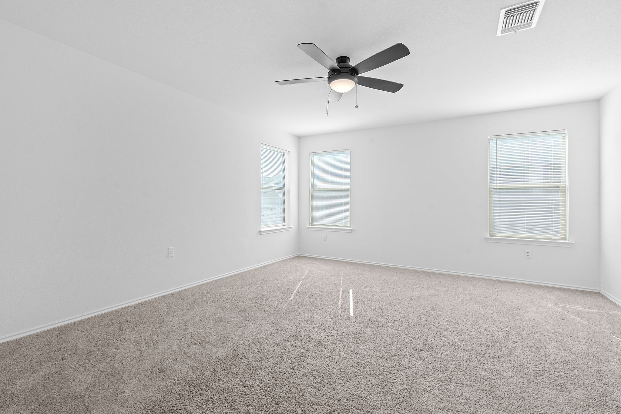 4720 Pell Rd Manor Manor, TX 78653 - Photo 13 of 31 an empty room with windows and fan