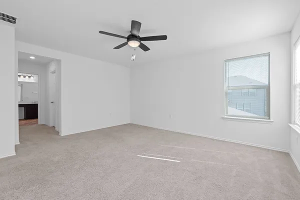 a view of a livingroom with a ceiling fan and window