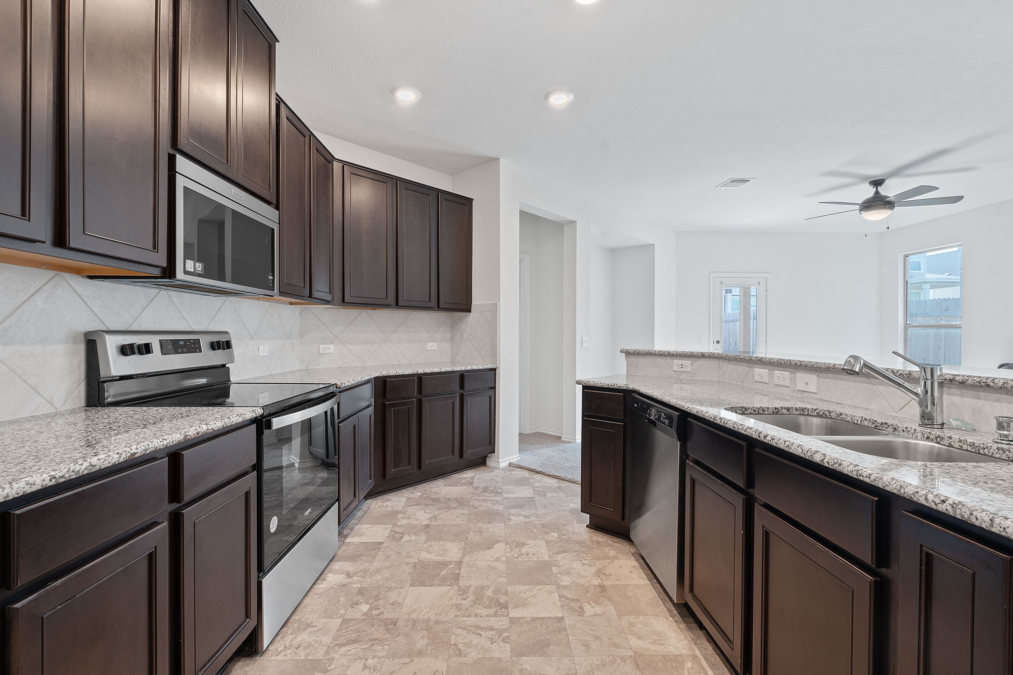 4720 Pell Rd Manor Manor, TX 78653 - Photo 4 of 31 a kitchen with granite countertop stainless steel appliances and sink