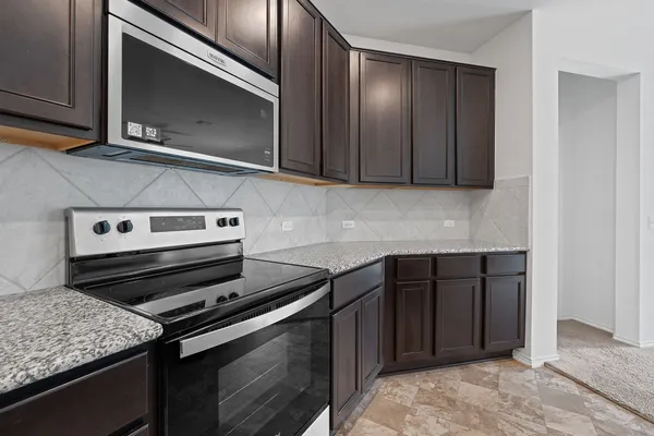 a kitchen with a stove and a microwave