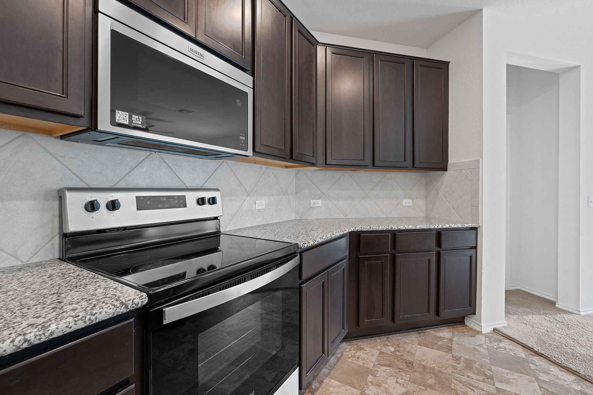 4720 Pell Rd Manor Manor, TX 78653 - Photo 5 of 31 a kitchen with a stove and a microwave
