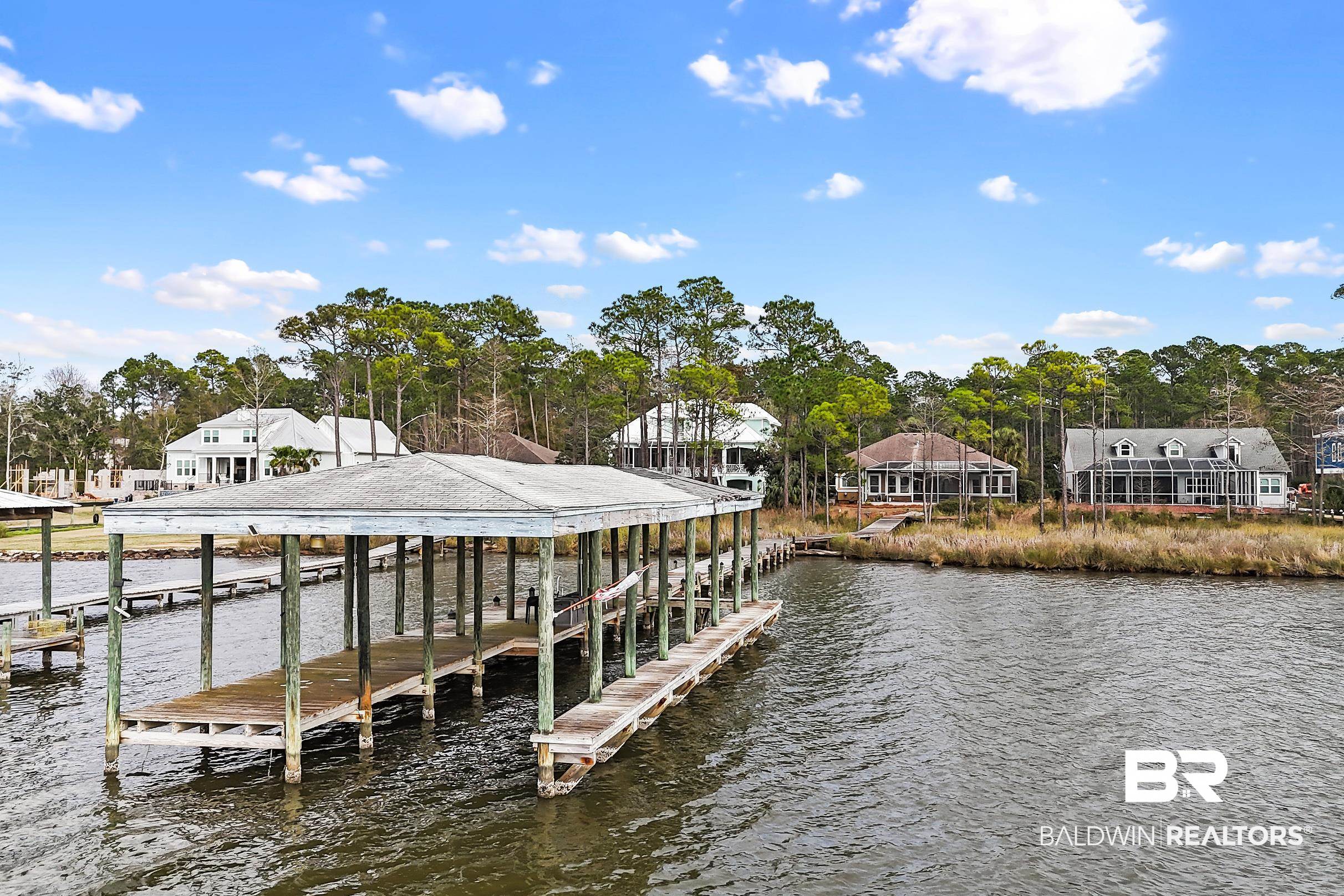 8591 Bay Harbor Road Elberta, AL 36530 - Photo 9 of 56 Dock area with boat lift, a water view, and view of scattered trees