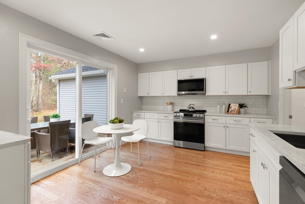 1 Barracks Road, Unit 1 Hudson, MA 01749 - Photo 16 of 29 a kitchen with a stove a sink and a refrigerator