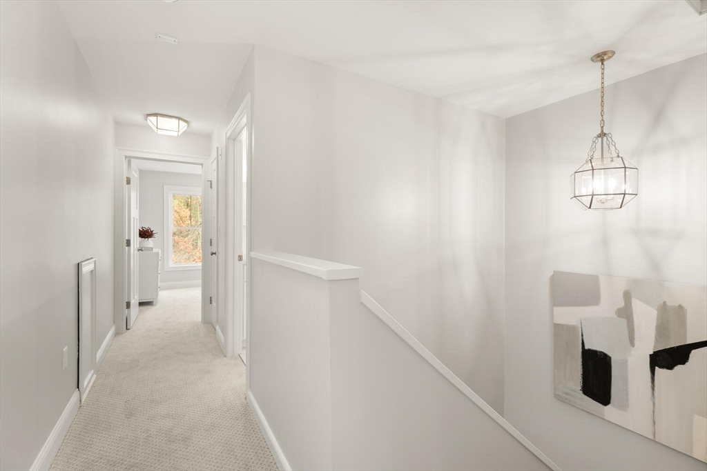 1 Barracks Road, Unit 1 Hudson, MA 01749 - Photo 17 of 29 a view of a hallway with wooden floor