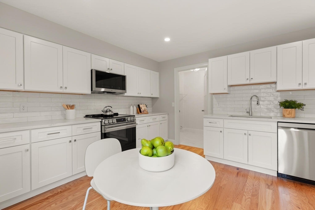 1 Barracks Road, Unit 1 Hudson, MA 01749 - Photo 23 of 29 a kitchen with a white stove top oven and white cabinets