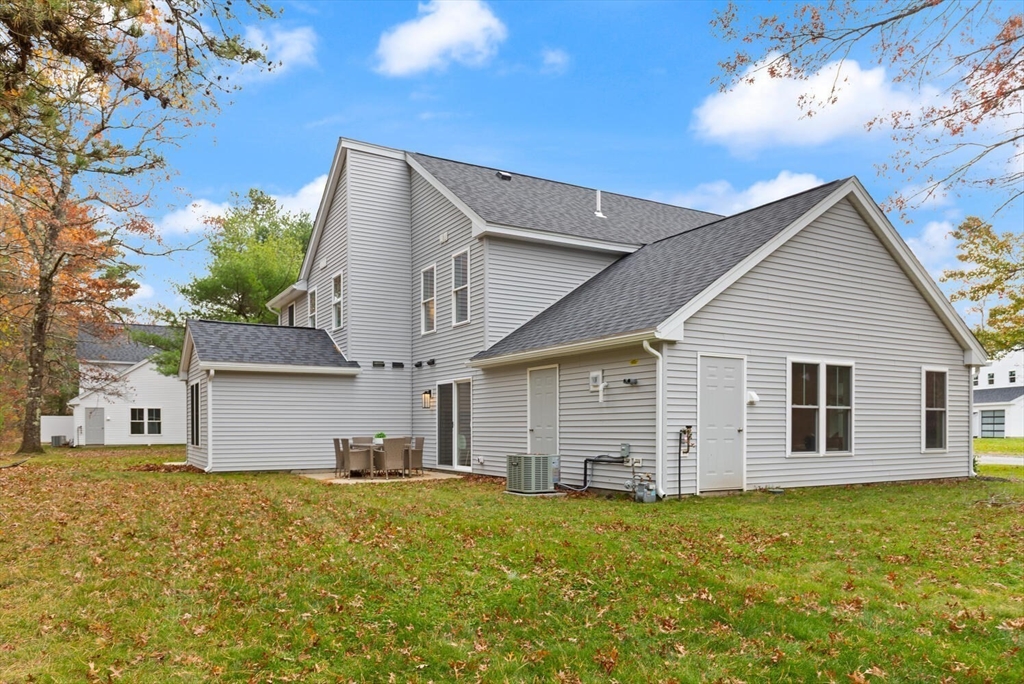 1 Barracks Road, Unit 1 Hudson, MA 01749 - Photo 27 of 29 a backyard of a house with table and chairs