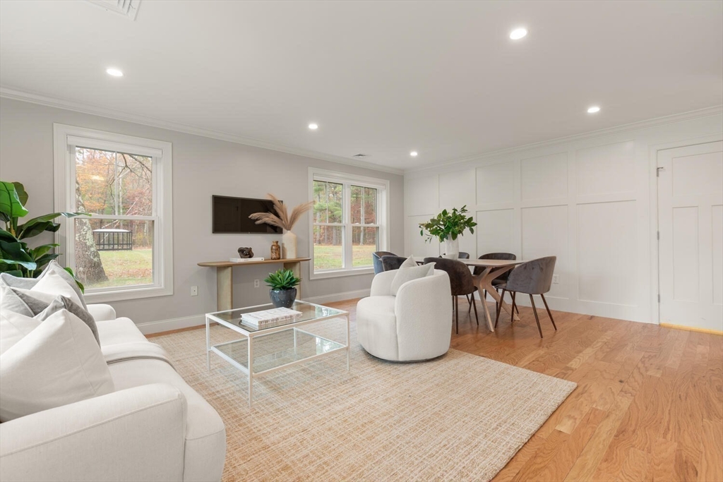 1 Barracks Road, Unit 1 Hudson, MA 01749 - Photo 10 of 29 a living room with furniture a fireplace and a flat screen tv
