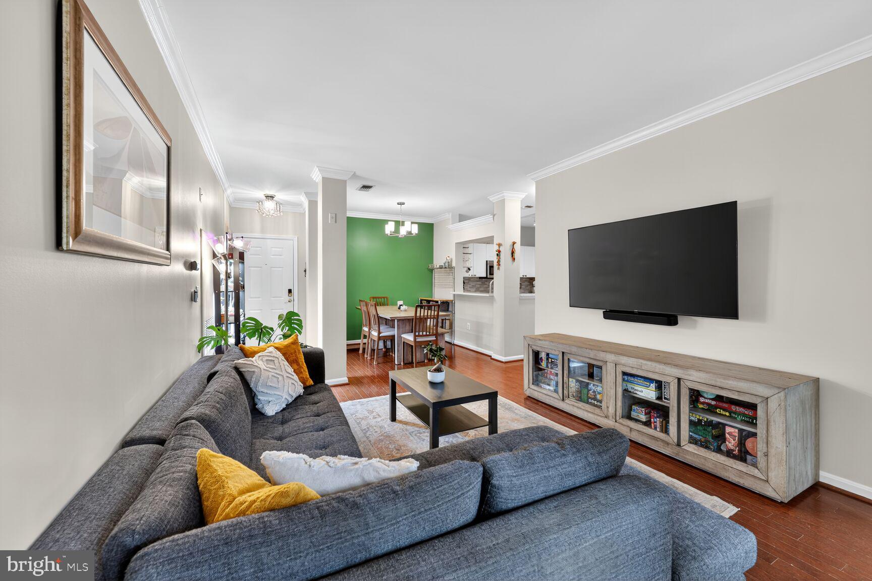 4561 Strutfield Lane, Unit 3211 Alexandria, VA 22311 - Photo 4 of 14 a living room with furniture and a flat screen tv