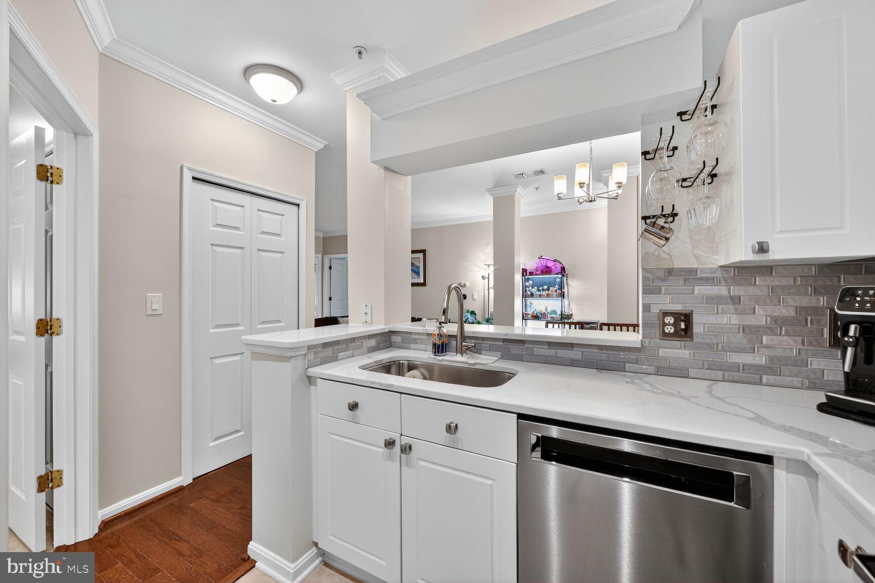 4561 Strutfield Lane, Unit 3211 Alexandria, VA 22311 - Photo 8 of 14 a view of a kitchen sink cabinets and wooden floor