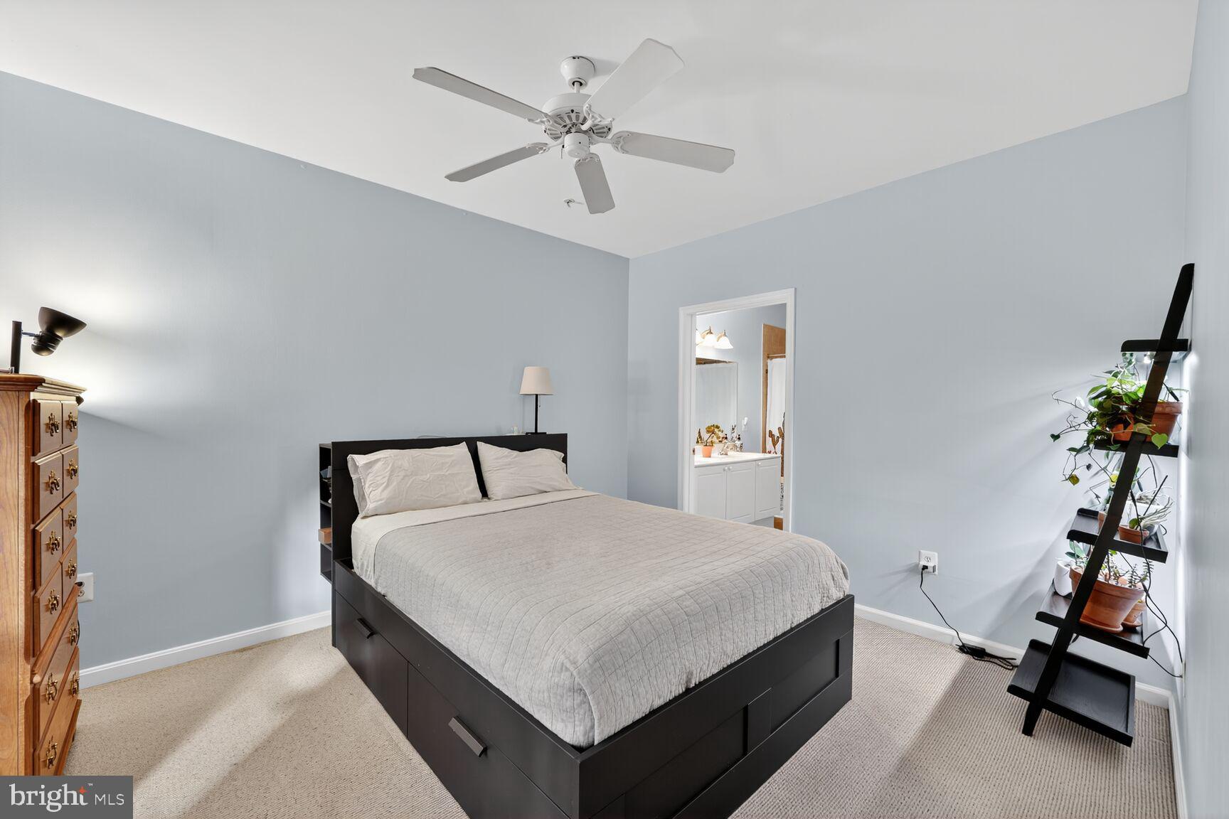 4561 Strutfield Lane, Unit 3211 Alexandria, VA 22311 - Photo 9 of 14 a room with a bed and a chandelier