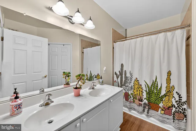 a bathroom with a double vanity sink and a mirror