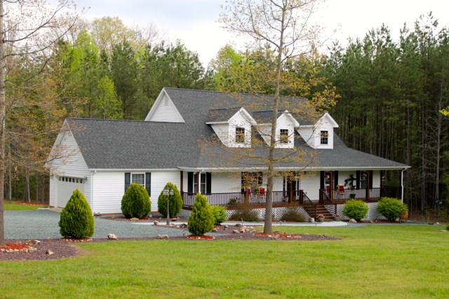 4031 Venable Road Kents Store, VA 23084 - Photo 2 of 47 a view of a white house with a big yard and potted plants