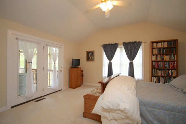 4031 Venable Road Kents Store, VA 23084 - Photo 23 of 47 a bedroom with a bed and a chandelier