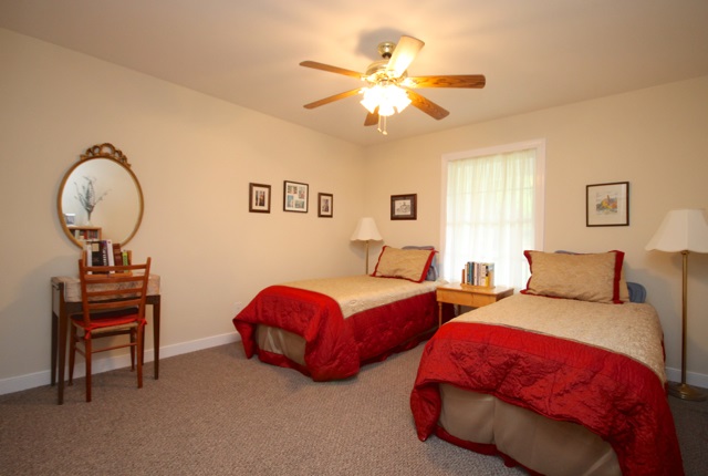 4031 Venable Road Kents Store, VA 23084 - Photo 28 of 47 a bedroom with two beds and a chandelier