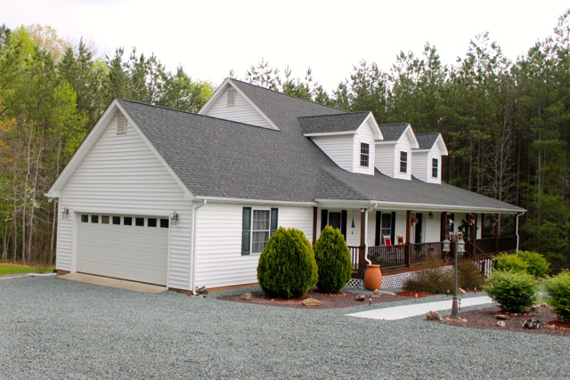 4031 Venable Road Kents Store, VA 23084 - Photo 3 of 47 a view of a white house with large windows and a table and chairs
