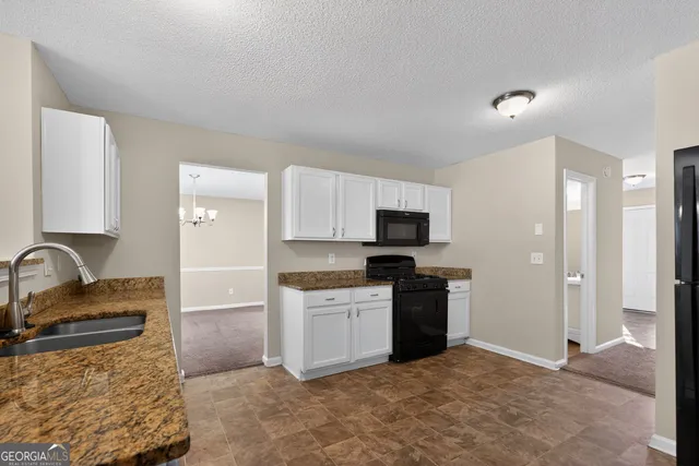 a kitchen with a sink and refrigerator