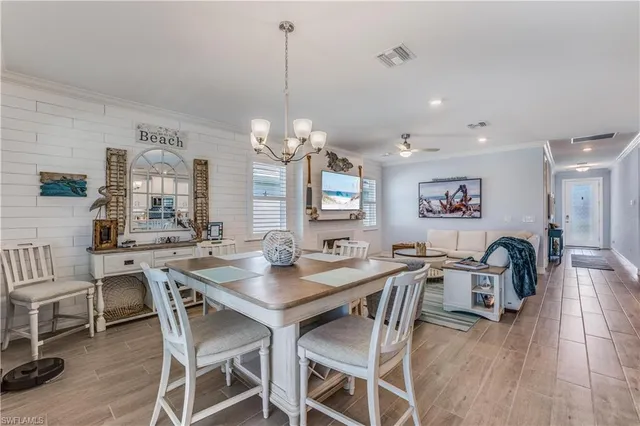 a view of a dining room with furniture and chandelier