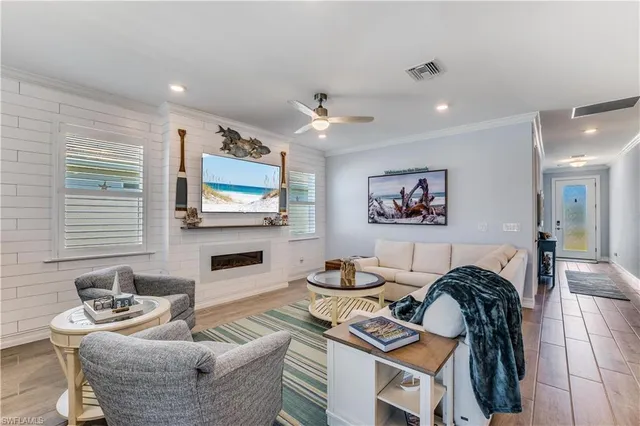 a living room with furniture a flat screen tv and a fireplace