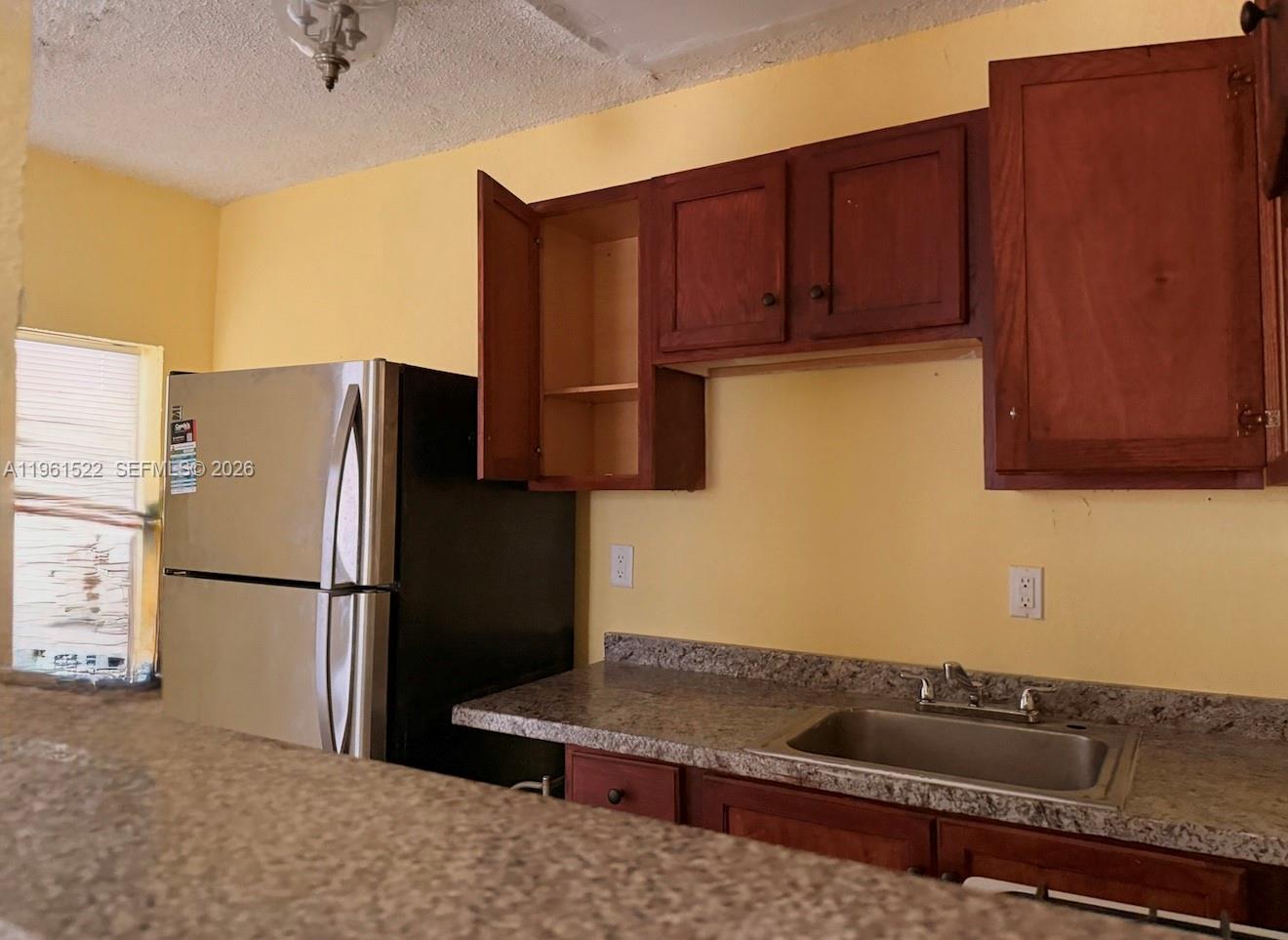 3615 Thomas Avenue, Unit 3 Miami, FL 33133 - Photo 4 of 12 a kitchen with stainless steel appliances granite countertop a refrigerator a stove and a sink