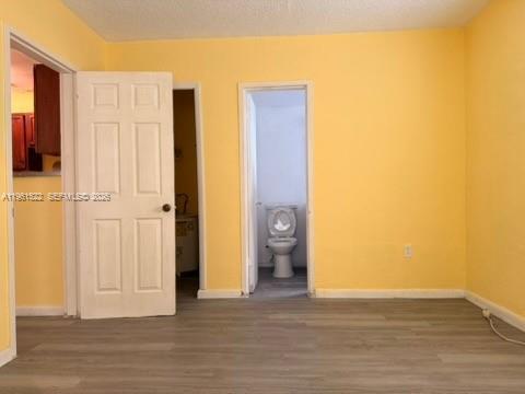 3615 Thomas Avenue, Unit 3 Miami, FL 33133 - Photo 5 of 12 a view of a livingroom with wooden floor and closet