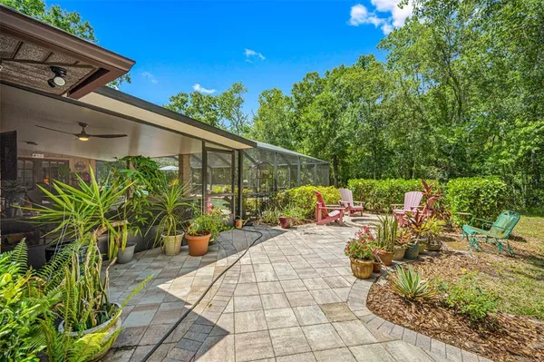 a view of swimming pool with seating area and yard in back