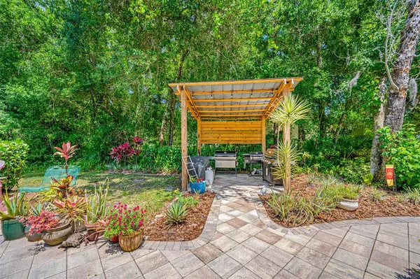a patio with a table and chairs under an umbrella