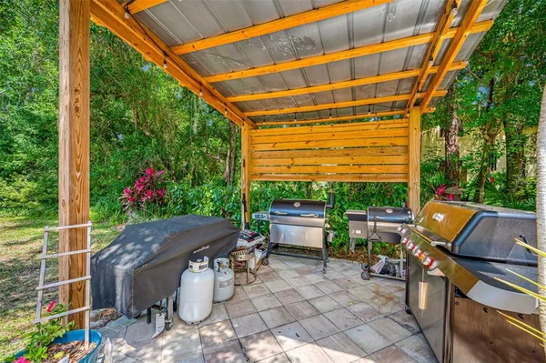 a view of a patio with a table and chairs under an umbrella