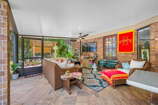 a living room with furniture kitchen view and a chandelier