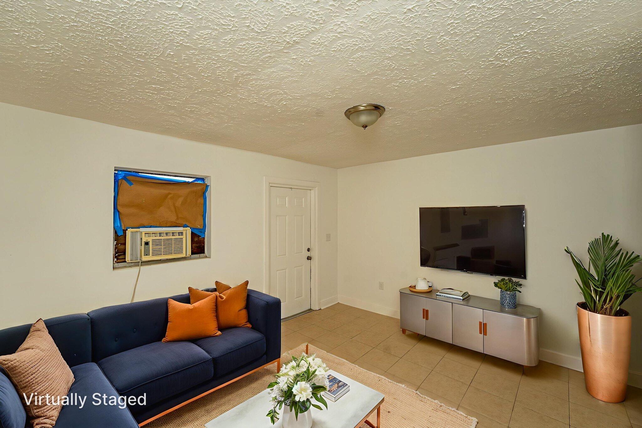 2108 Avenue East Fort Pierce, FL 34950 - Photo 11 of 32 a living room with furniture and a flat screen tv